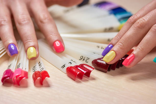 istock Girls fingers with multicolored nails. 853589136