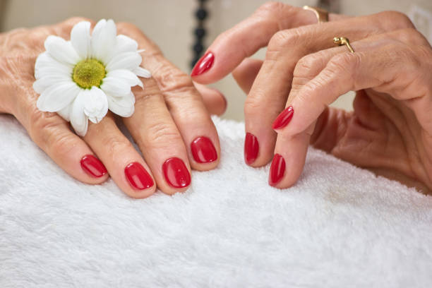 istock Female hands with manicure on towel. 853597672
