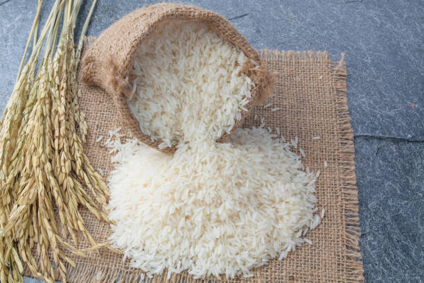istock thai fragrant jasmine rice in a spoon with gold spike on Sack 853601374
