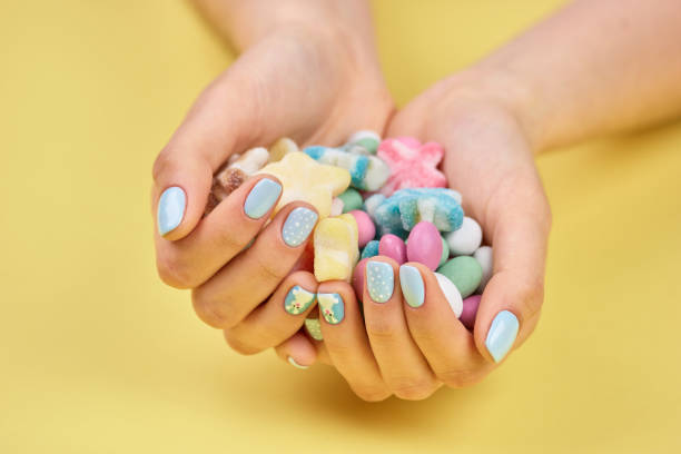 istock Colorful candies in womans hands. 853602106