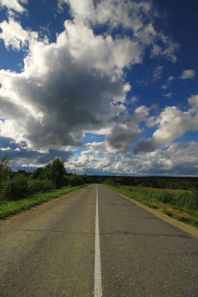 istock road in the field cloudy landscape 853603338