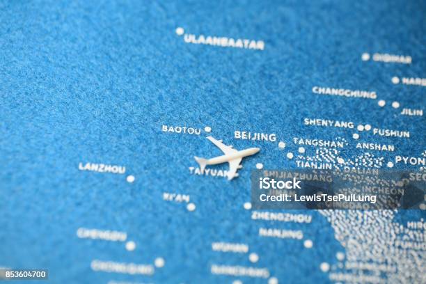 Airplane Fly On The Blue Painted Map Stock Photo - Download Image Now - Commercial Airplane, Beijing, Flying