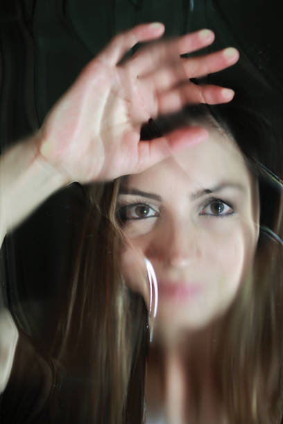 istock girl face behind glass 853608986