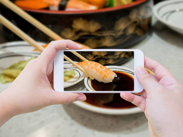 istock Taking photo of prawn sushi in chopsticks 853609184