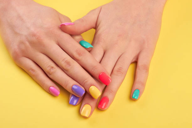 istock Woman nails painted in different colors. 853609968
