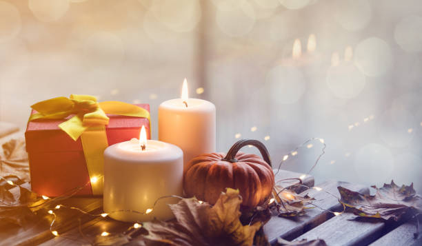 istock pumpkin, gifts and candles with maple leaves 853610672