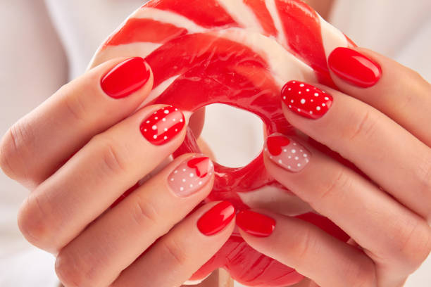 istock Large lollipop in manicured hands. 853611110