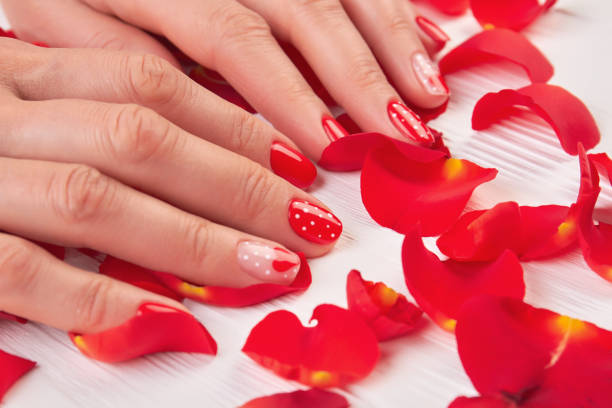 istock Woman red nails and rose petals. 853613476
