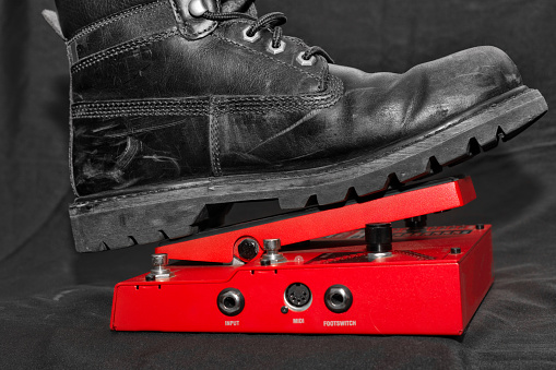 A worker boot over a guitar effect pedal