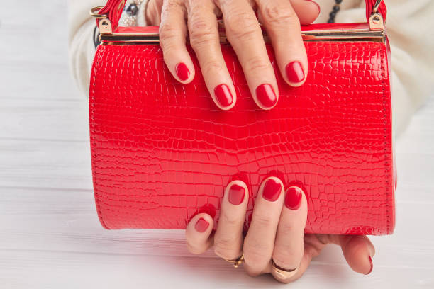 istock Elegant red handbag in female hands. 853622774