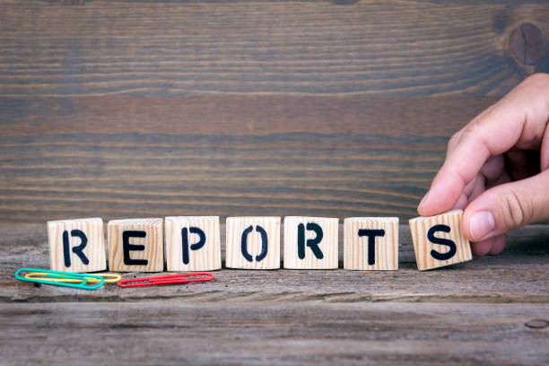 istock Reports. Wooden letters on the office desk, informative and communication background 853645442