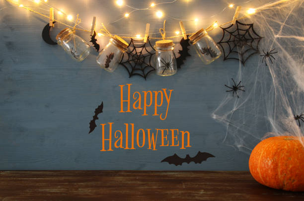 istock Halloween holiday concept. Masson jars with spiders, baths and wooden decorations 853646568