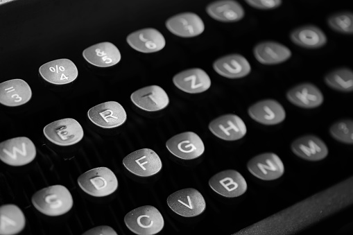A black and white shot of an antique typewriter's keyboard.