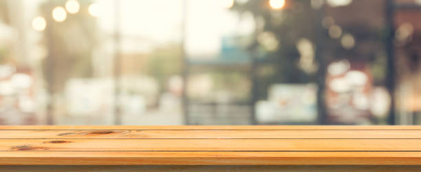 istock Wooden board empty table top blurred background. Perspective brown wood table over blur in coffee shop background. Panoramic banner - can be used mock up for montage products display or design. 853652450