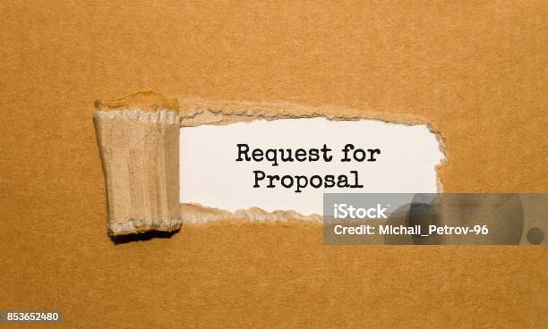 The Text Request For Proposal Appearing Behind Torn Brown Paper Stock Photo - Download Image Now