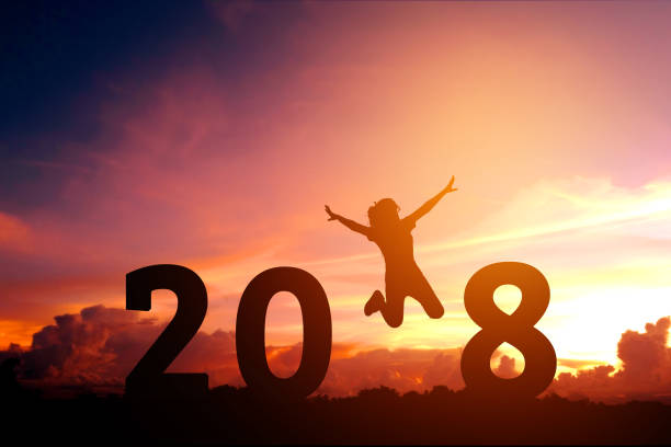 istock Silhouette young woman jumping to 2018 new year 853653018
