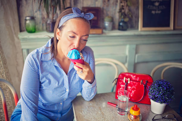 istock Woman enjoying a sundae in cafe 853664598