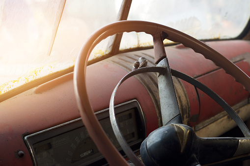 Classic car interior and old steering wheel