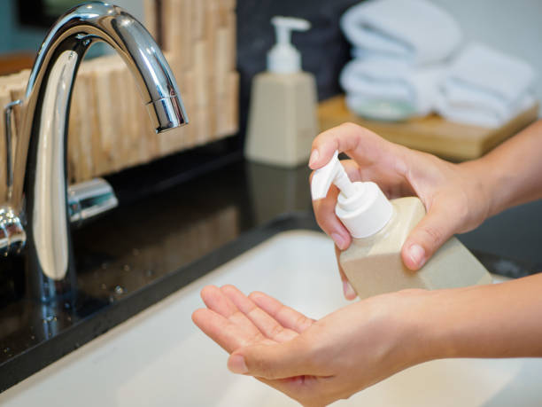 istock Closeup woman pressing the liquid soap to her hand. 853676560