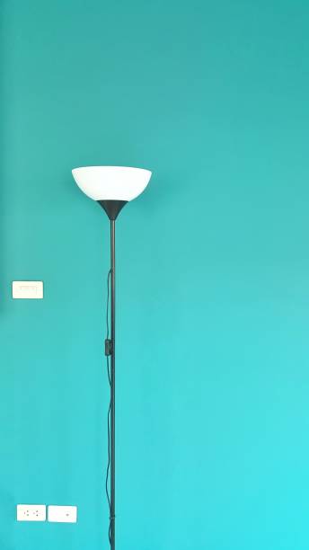istock Black lamp on the right with a green background. 853691762