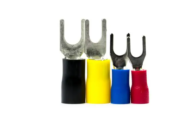 Photo of Red, blue, yellow and black color of spade terminals electrical cable connector accessories isolated on white background with clipping path