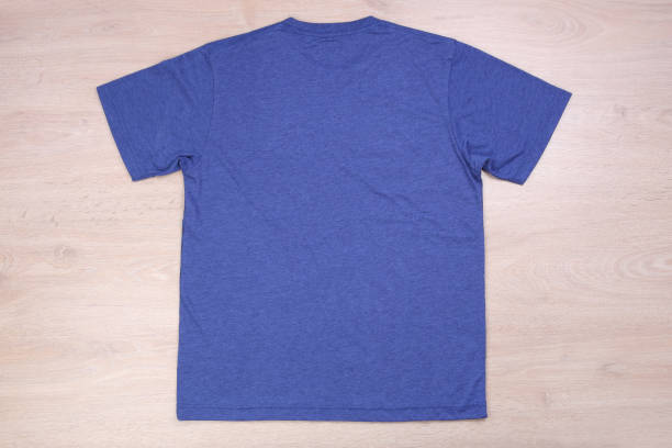 istock Back view blue tshirt on wooden background 853715070