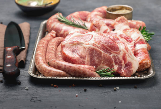 istock raw steaks and sausages with spices on a tray 853724730