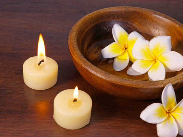 istock two cadles and tropical flowers 853728588