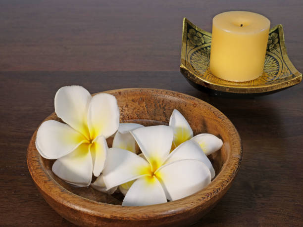istock white candle and tropical flowers 853731016
