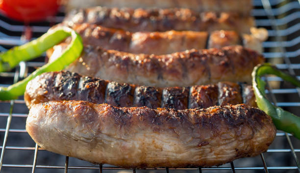 istock Grilling sausages on barbecue grill. Selective focus. 853736032
