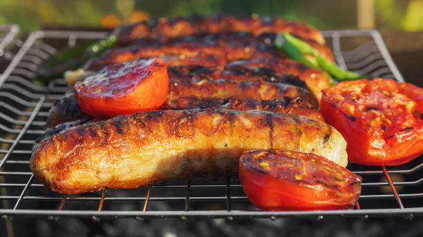 Grilling sausages on barbecue grill. Selective focus. stock photo