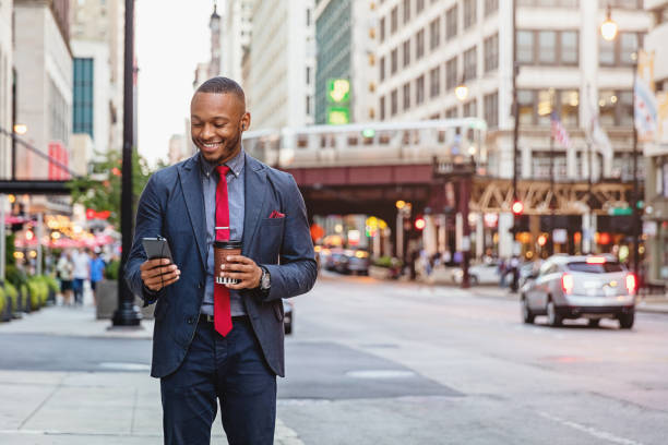 Smiling business commuter using smart phone chicago streets