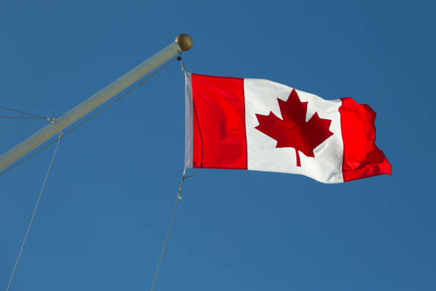 istock Canadian Flag against blue sky 853745592
