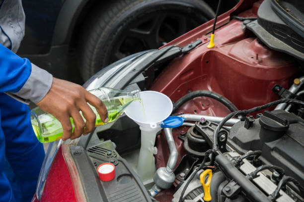 istock Mechanic Pouring Oil Into The Car Engine 853749744