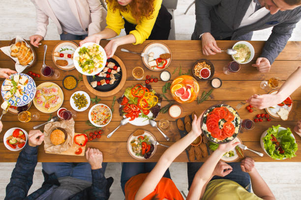 istock People eat healthy meals at served table dinner party 853750148