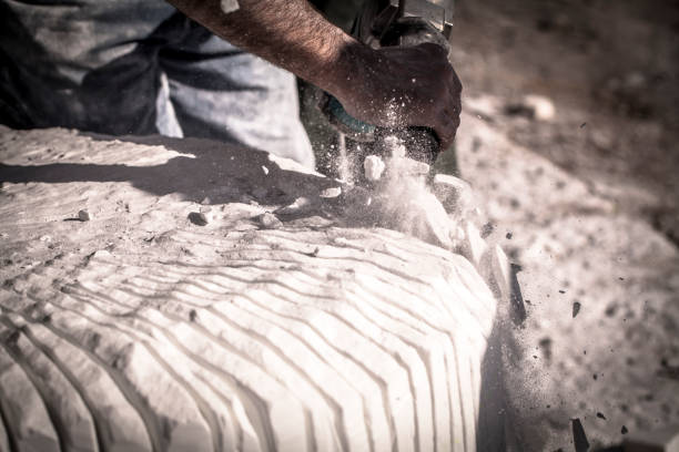 istock Artist sculpting marble with pneumatic hammer 853752676