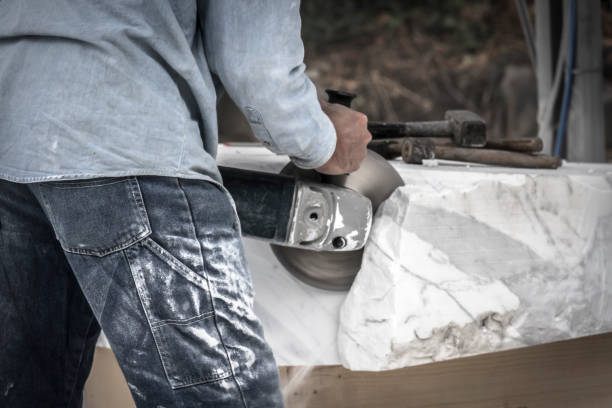 istock Artist cutting marble stone with angle sander and diamond disc 853753032