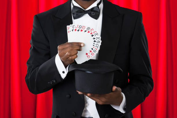 Close-up Of A Male Magician With Playing Cards And Hat