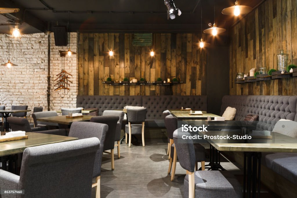 Cozy wooden interior of restaurant, copy space Cozy wooden interior of restaurant, copy space. Comfortable modern dining place, contemporary design background Restaurant Stock Photo