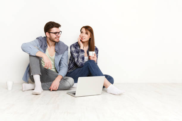 istock Couple at food delivery web site on laptop, calling on mobile to make an order 853760658