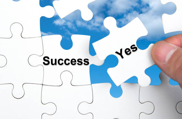 istock White jigsaw puzzle with Success and Yes word, business concept. 853761656