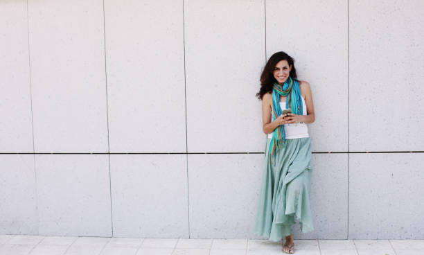 istock Beautiful woman is holding mobile phone 853773532