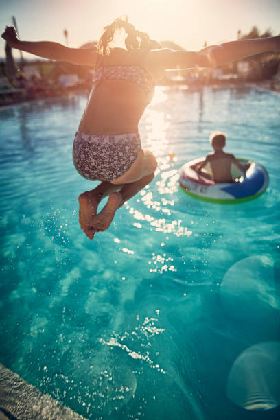 Brother and sister playing in the resort pool