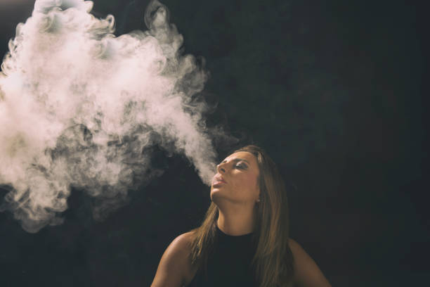 istock Young woman vaping 853779684