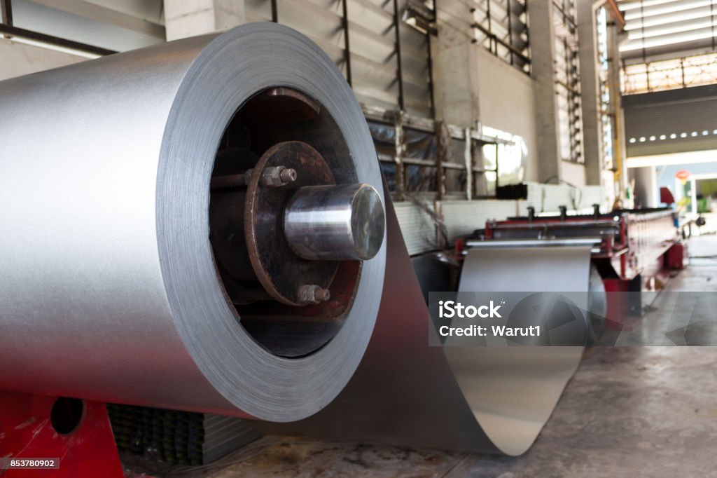 Metal Sheet tile manufacturing factory Metal Sheet tile manufacturing factory. Steel sheet with Zinc coated metal is rolled by  profiling forming machine. Cold Temperature Stock Photo
