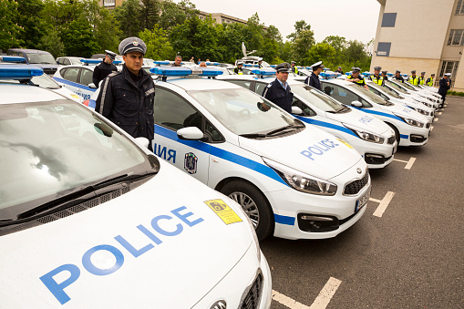 Sofia: Police officers stand beside their new patrol cars in the Ministry of the Interior during a ceremony showing the new vehicles. Surveillance and audio recording vehicles.