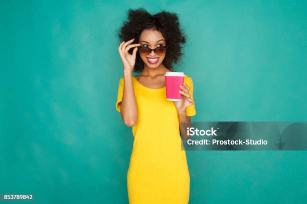 Happy Girl Drinking Coffe At Studio Background Stock Photo - Download Image Now - Coffee - Drink, Fun, Multi Colored