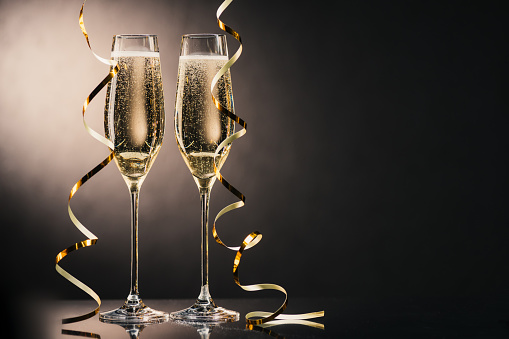close up view of two glasses of champagne with ribbons