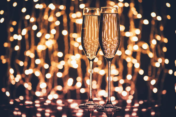 istock glasses of champagne against festive lights 853797676