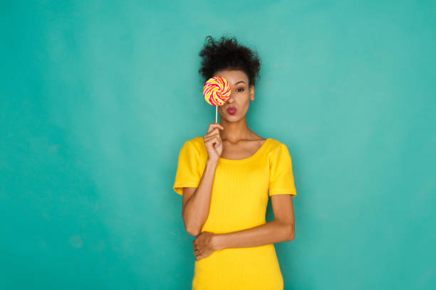 istock Happy girl with lollipop at studio background 853798080